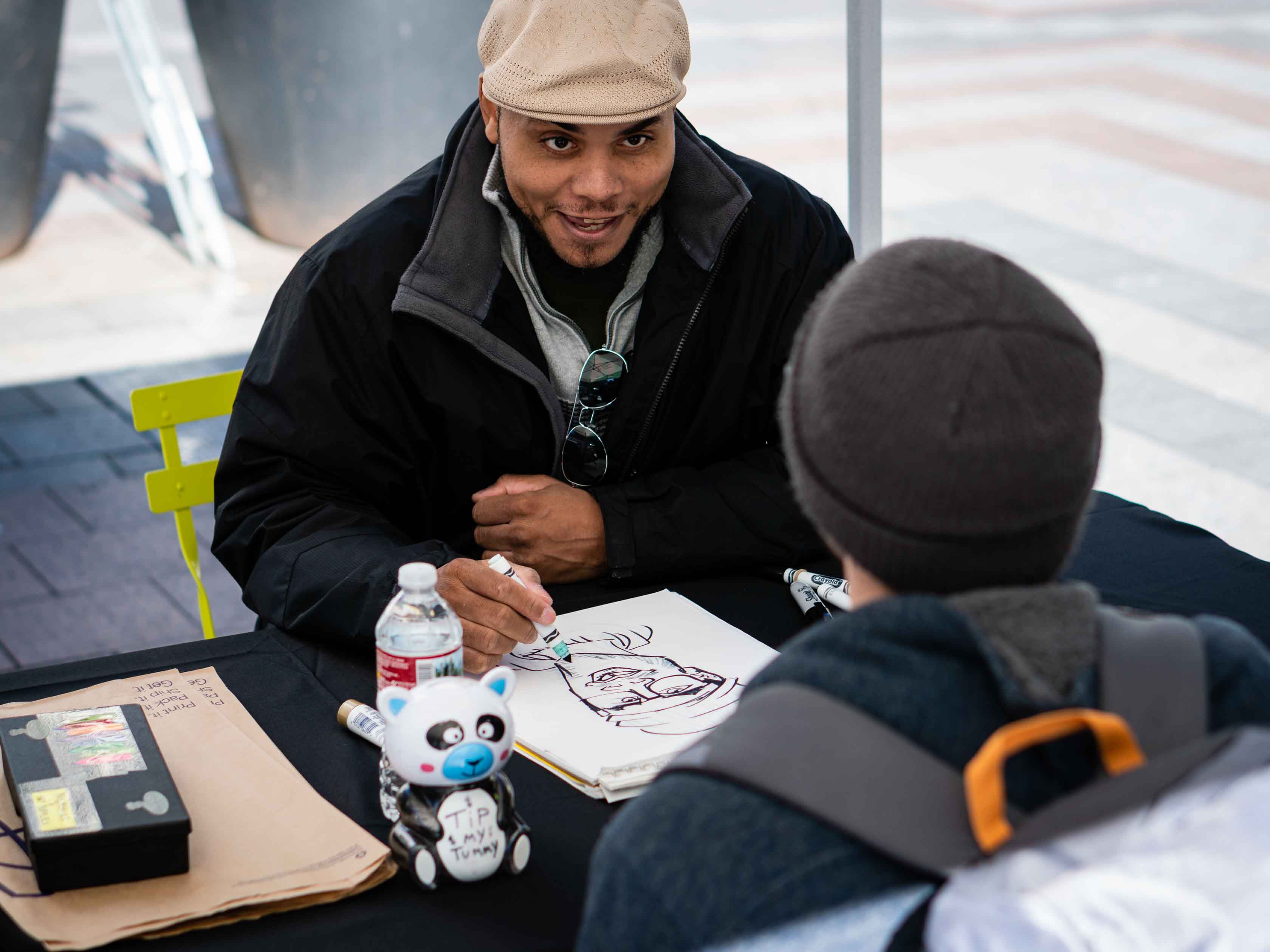 Caricature artist smiling and drawing.