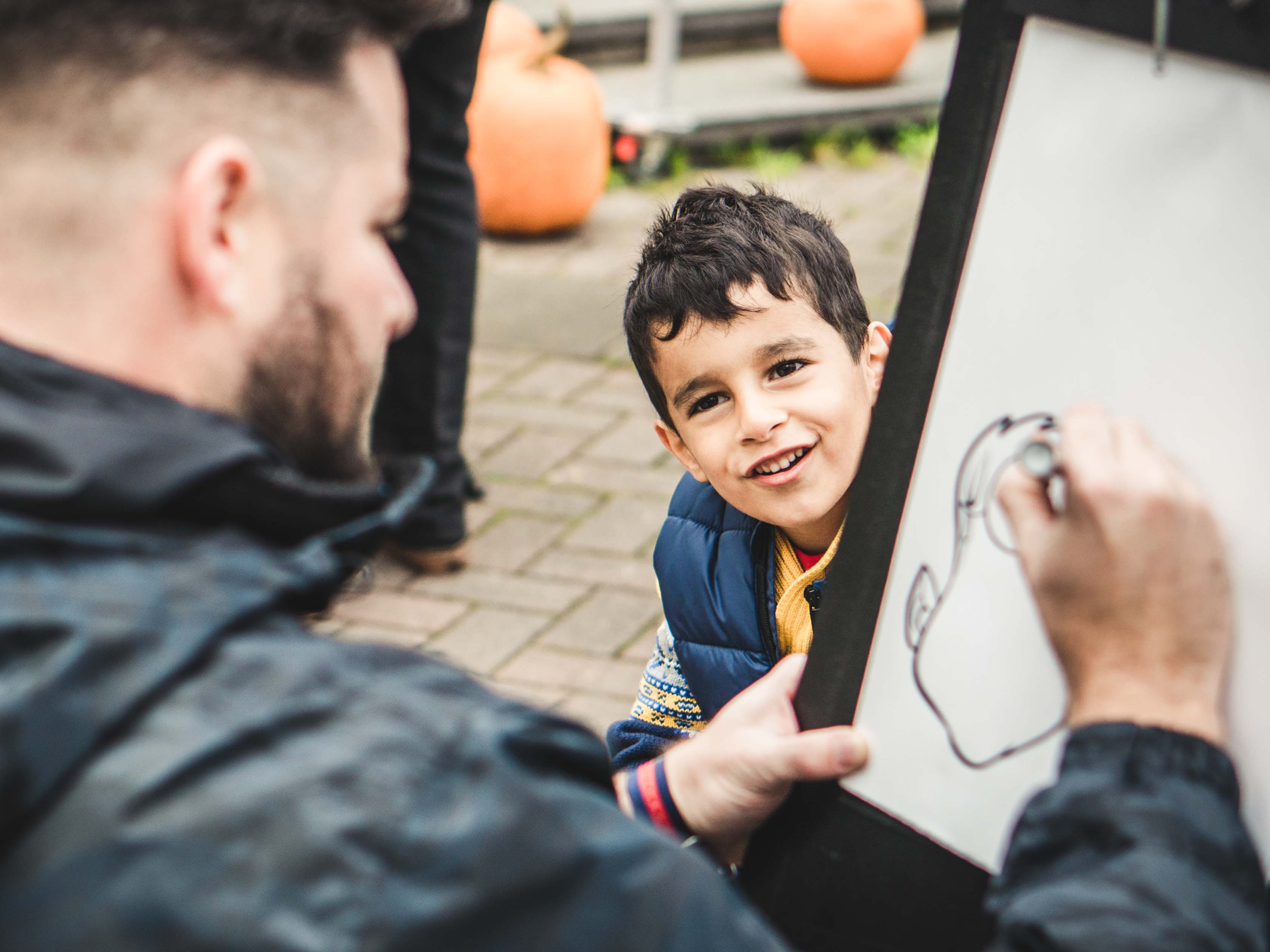 child posing for a caricature drawing