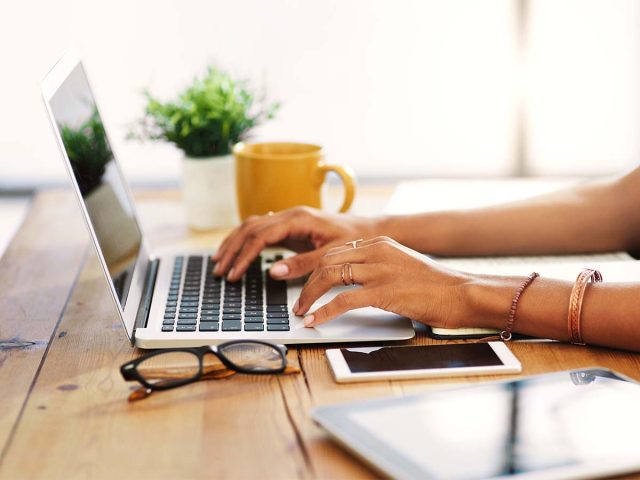 Typing at laptop
