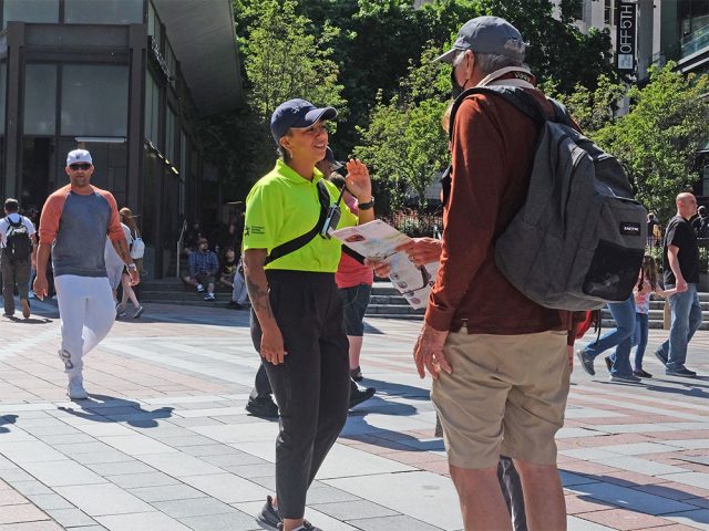 Safety Ambassador speaking with a downtown visitor