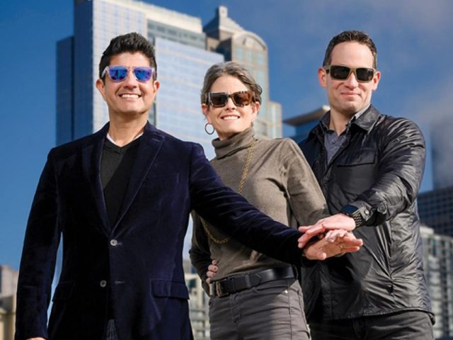 AP Diaz, Sara Nelson and Jon Scholes wearing sunglasses with Seattle cityscape behind them
