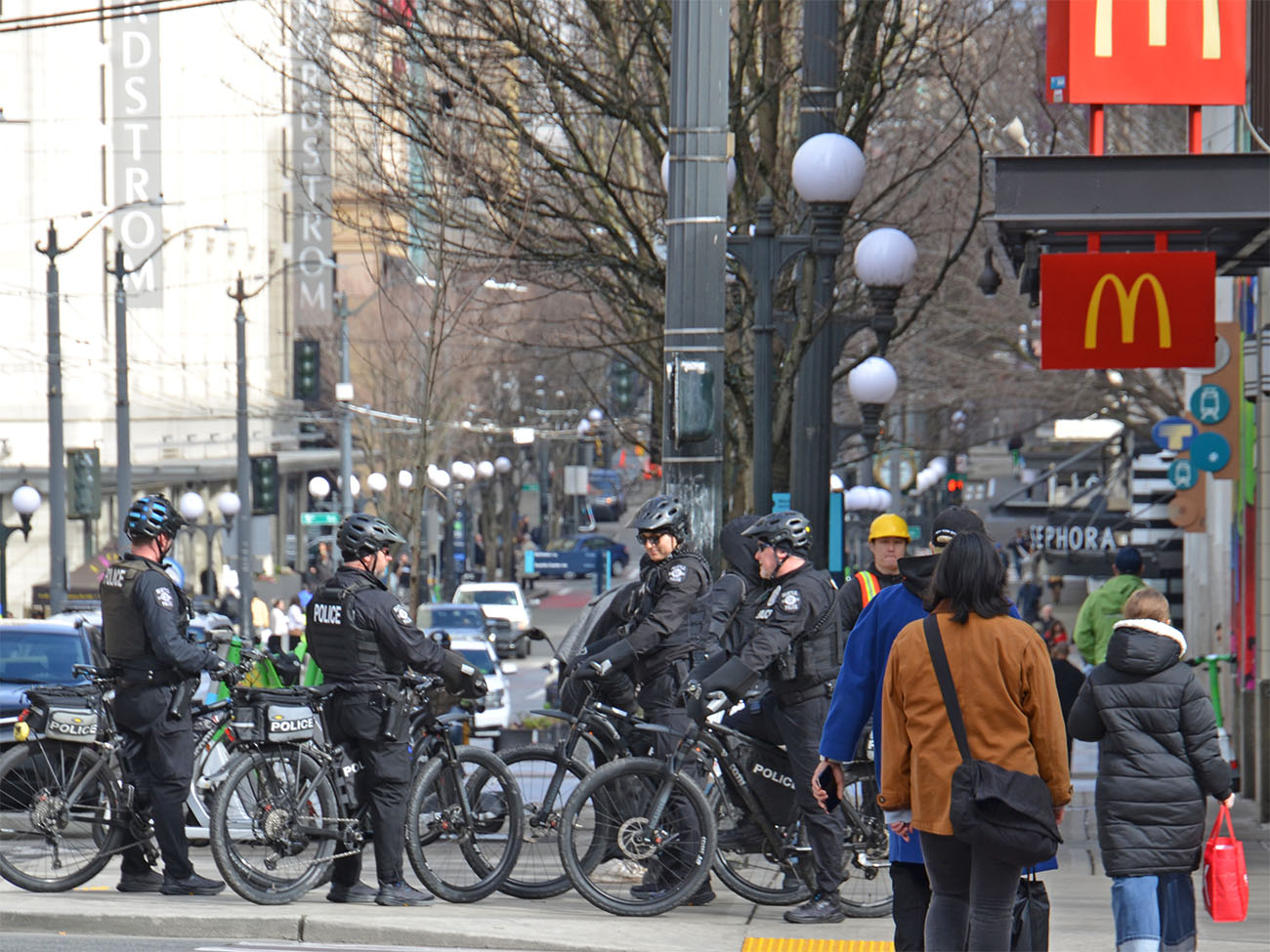 Group of Seattle police officers on bikes at 3rd Ave. & Pine St.