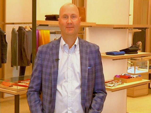 Scott Mitchell, a guest on the Seattle City Makers Podcast, poses for a photo inside Marios high-end clothing store.