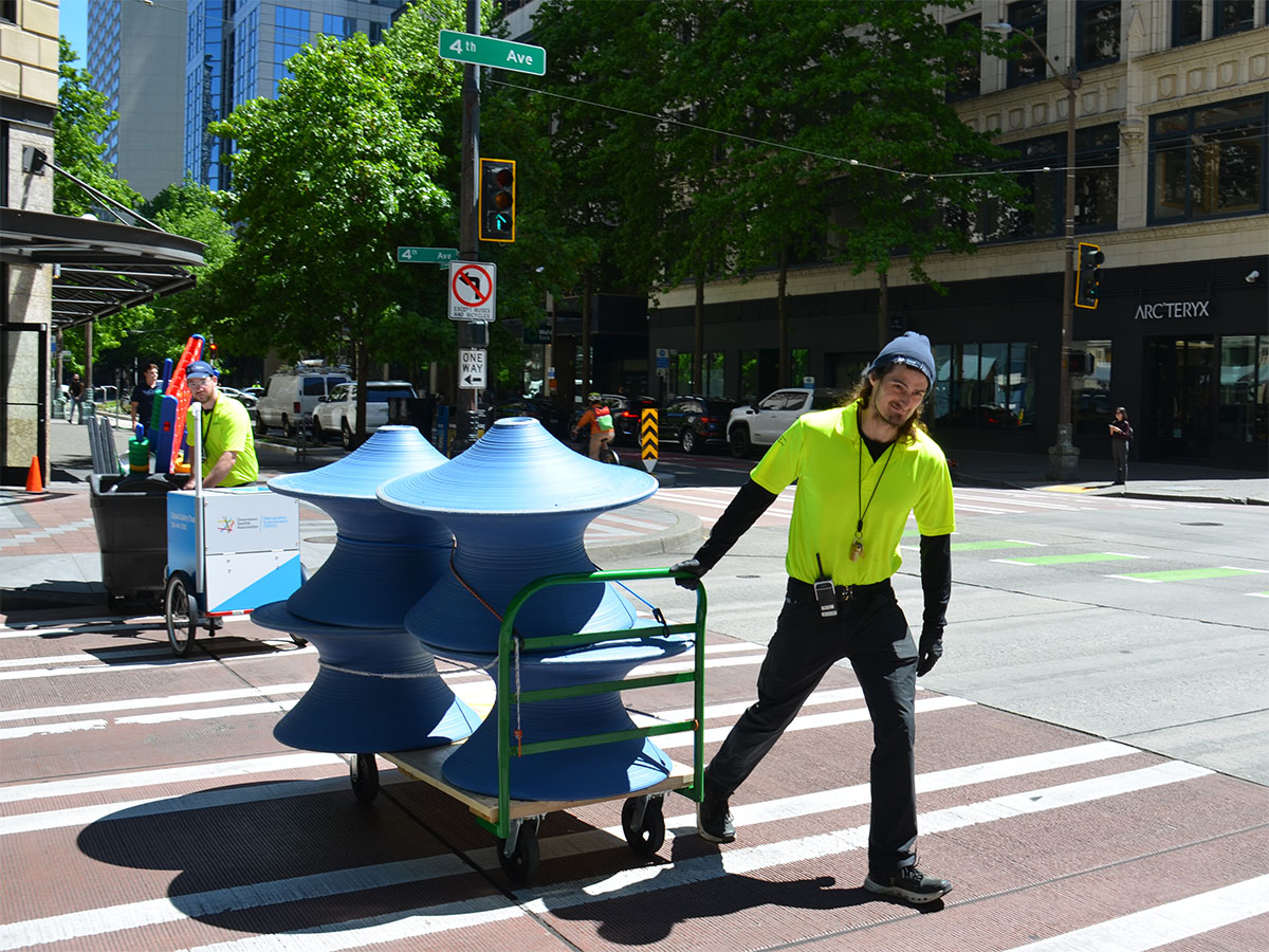Downtown ambassador transporting chairs