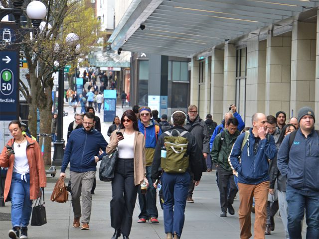 Commuters walking outside of the Westlake Park Link light rail station